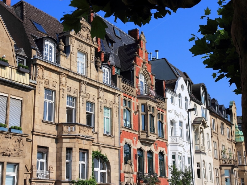 elegant cream, red brick and white painted gable fronted houses