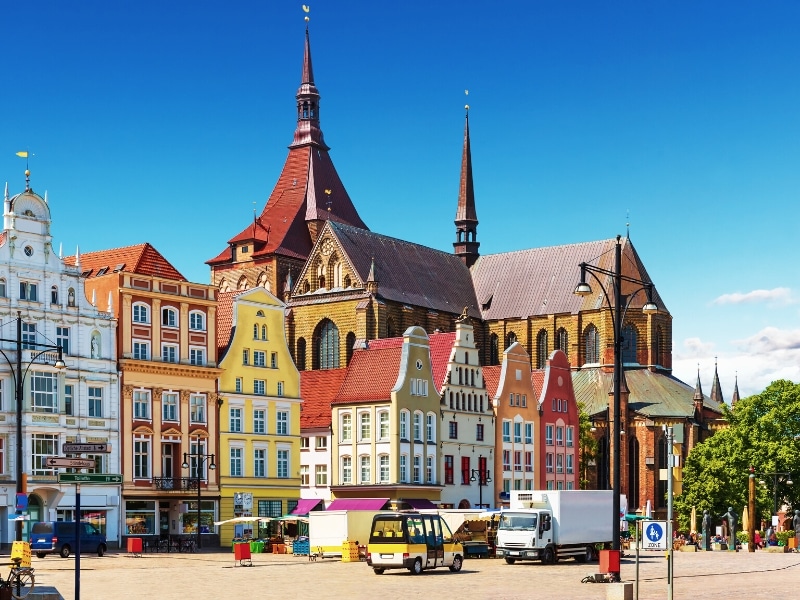 colorful houses with several spires in the background