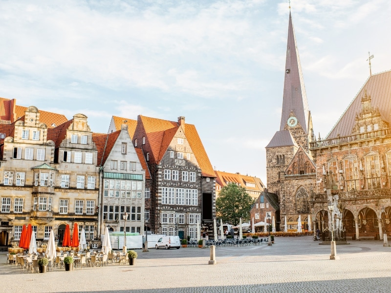 empty town square with a church and spire and elegant gable fronted houses
