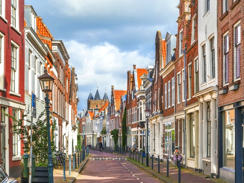 rows of traditional town houses either side of a narrow city street