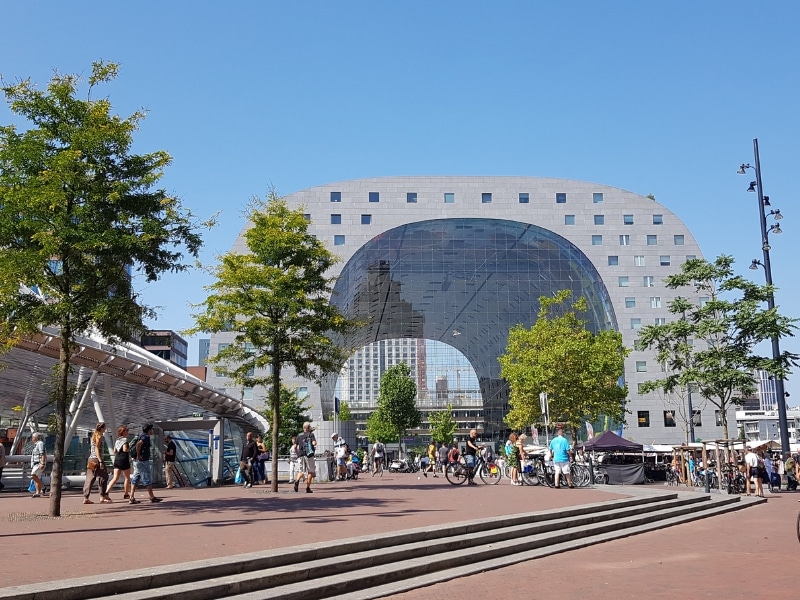 contemporary city center architecture surrouned by a red brick pavement and people riding bikes