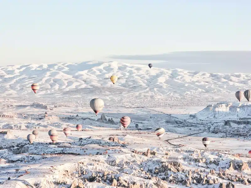 hot air balloons over a snowy landscape