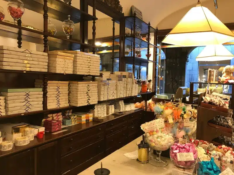 chocolate shop with boxes of sweet treats arranged on shelves