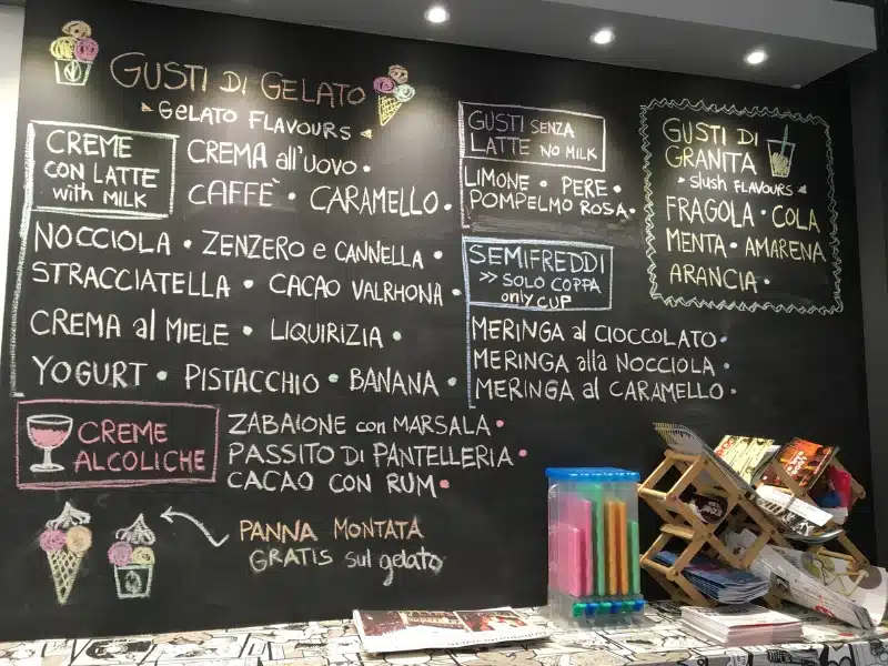 blackboard in a gelato shop advertising flavours in different coloured chalks
