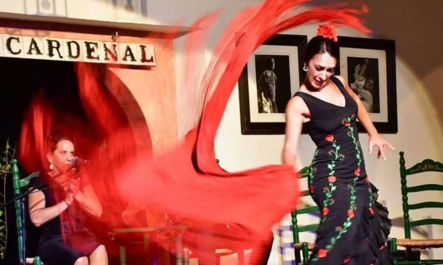 lady in black decorative dress dancing flamenco with a red scarf