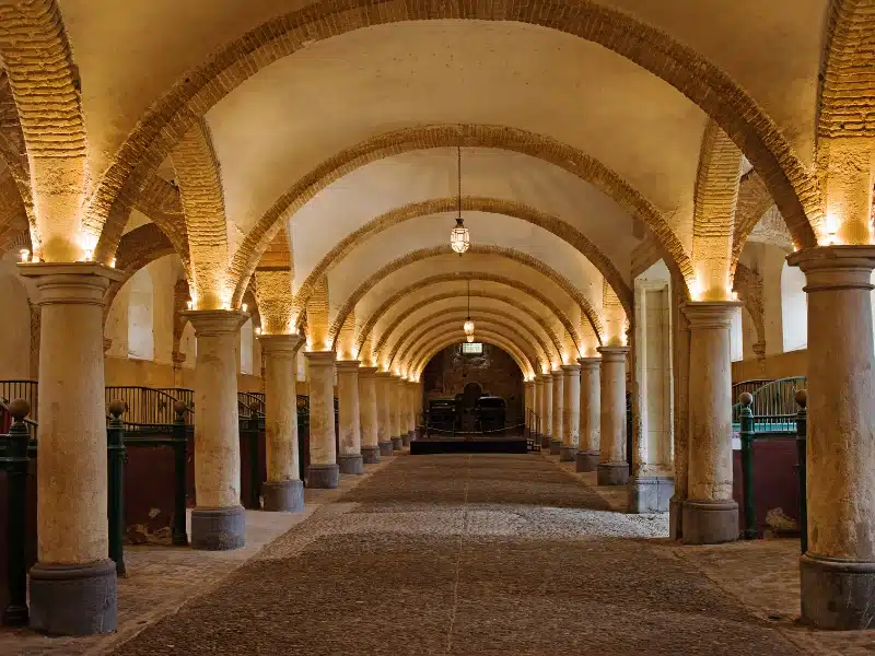 royal stables with domed ceilings and brick arches