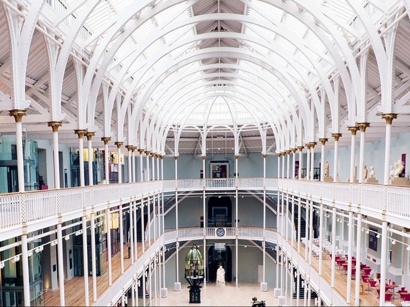domed inside of a museum with suspended walkways over three floors