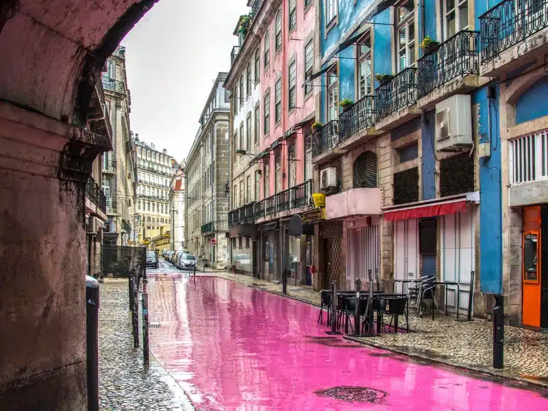 a pink street lined with colorful houses