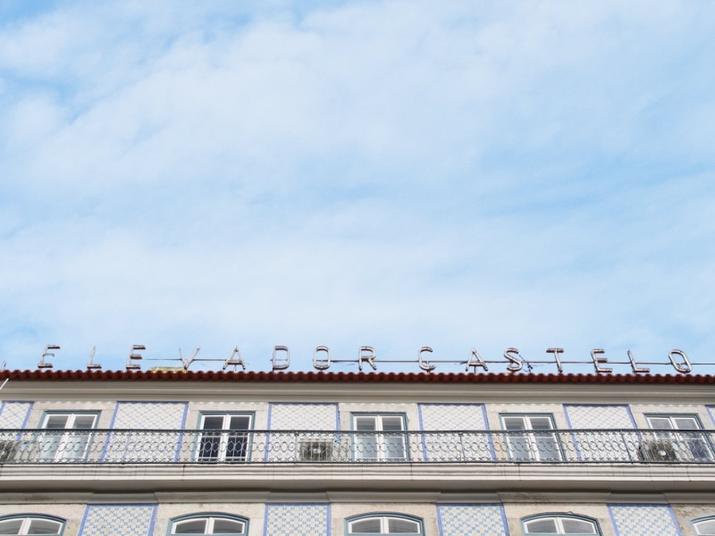Tiled building in Lisbon with a sign on top