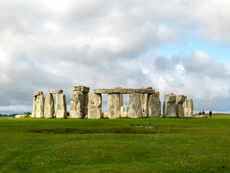 stonhenge on a spring day surrouned by grass and yellow flowers