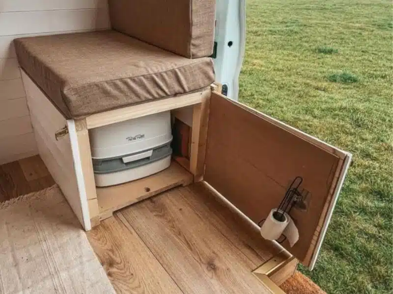porta potti stored in an under bench seat in a campervan
