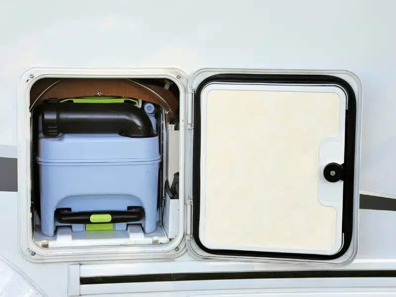 opening in a side of a motorhome with a door to reveral a toilet cassette