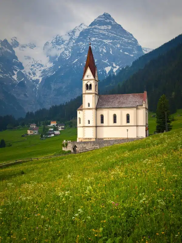 small white church in a grassy meadow