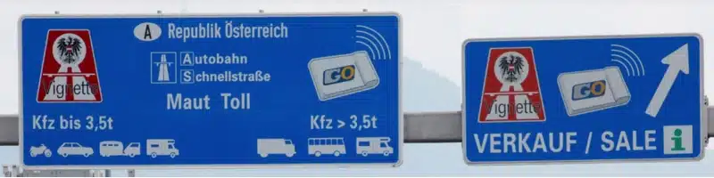 blue, white and red Austrian road signs advising drivers where to pay tolls