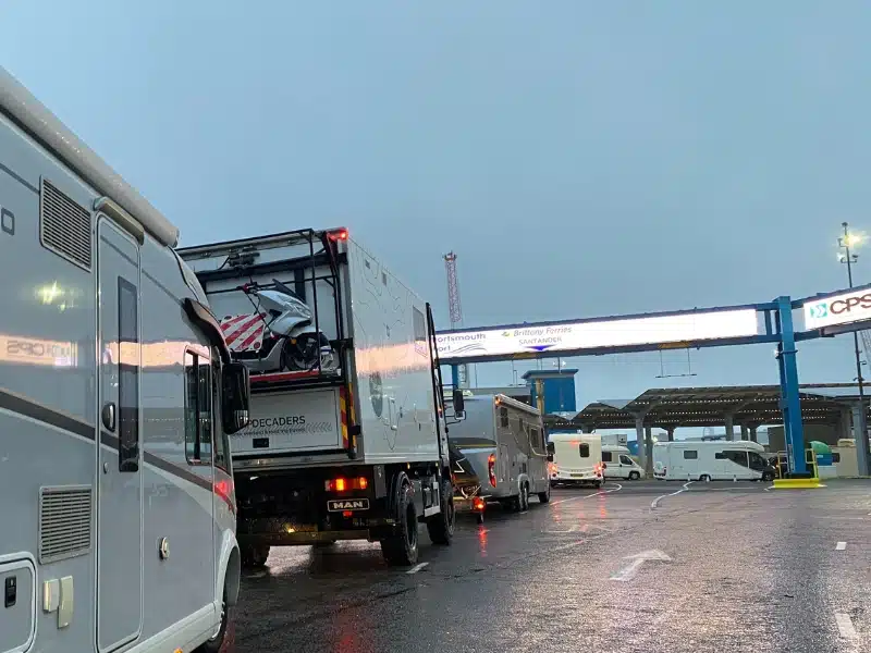 trucks and motorhomes lining up to board a ferry between UK and Spain