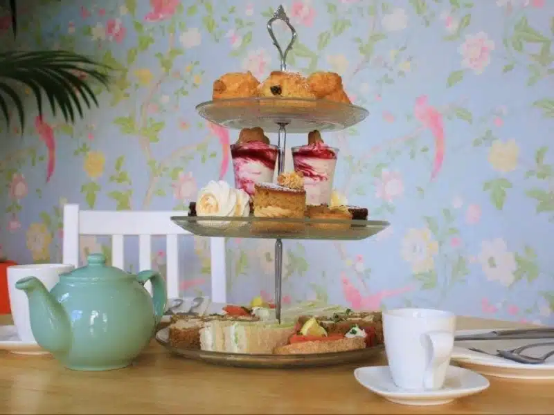 cake stand with sandwiches, scones and cakes