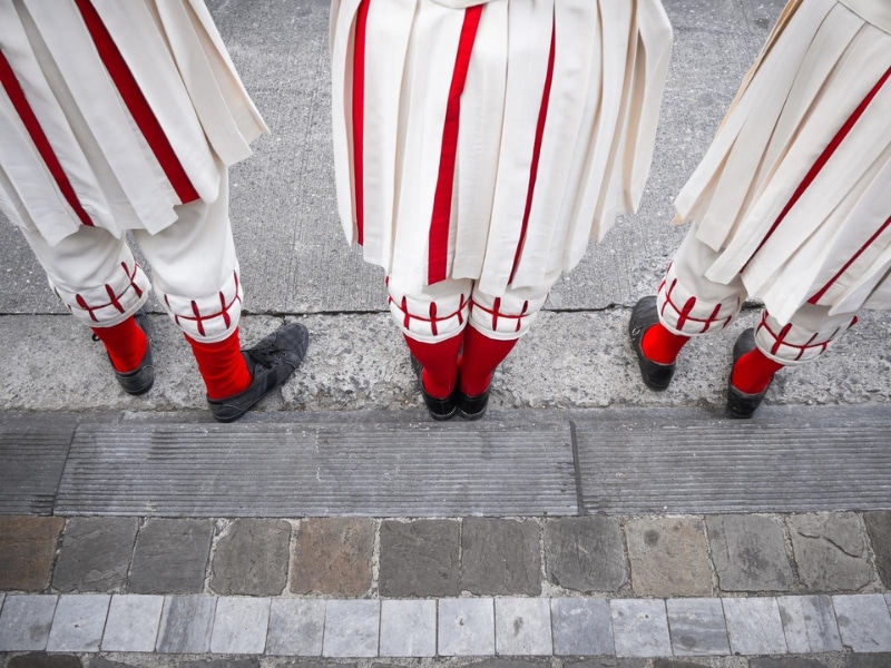 people wearing red and white clothing with red socks and black shoes