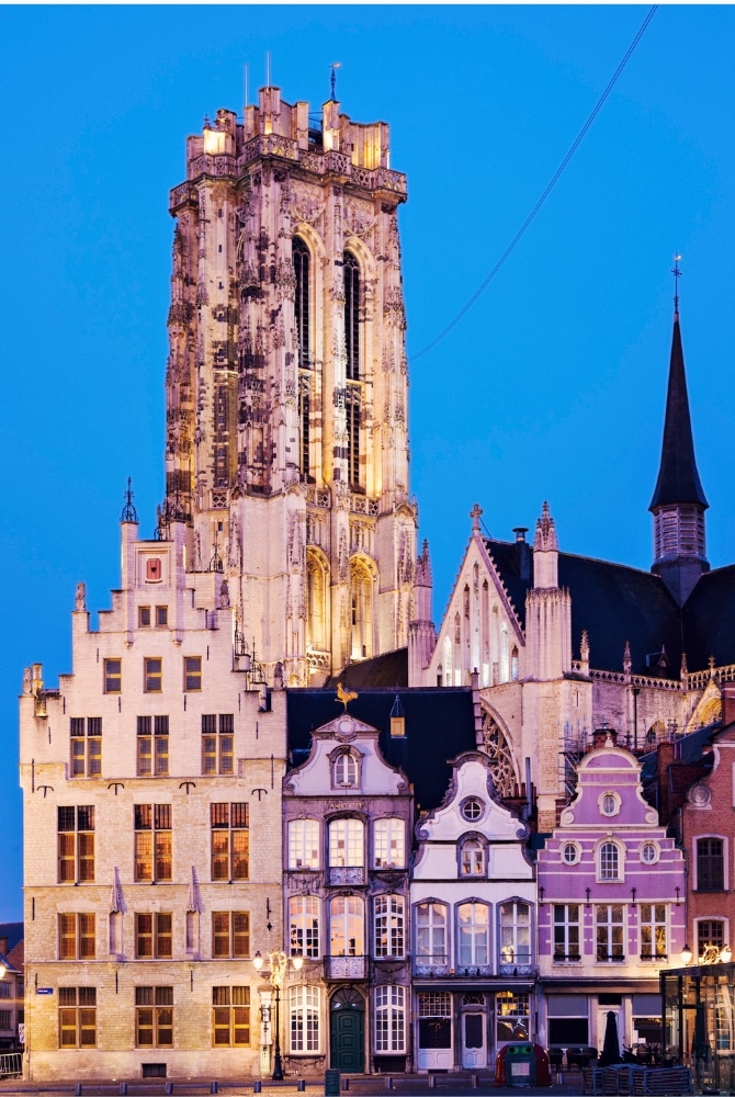 historic buildings with typical Dutch gable ends in front of a large tower