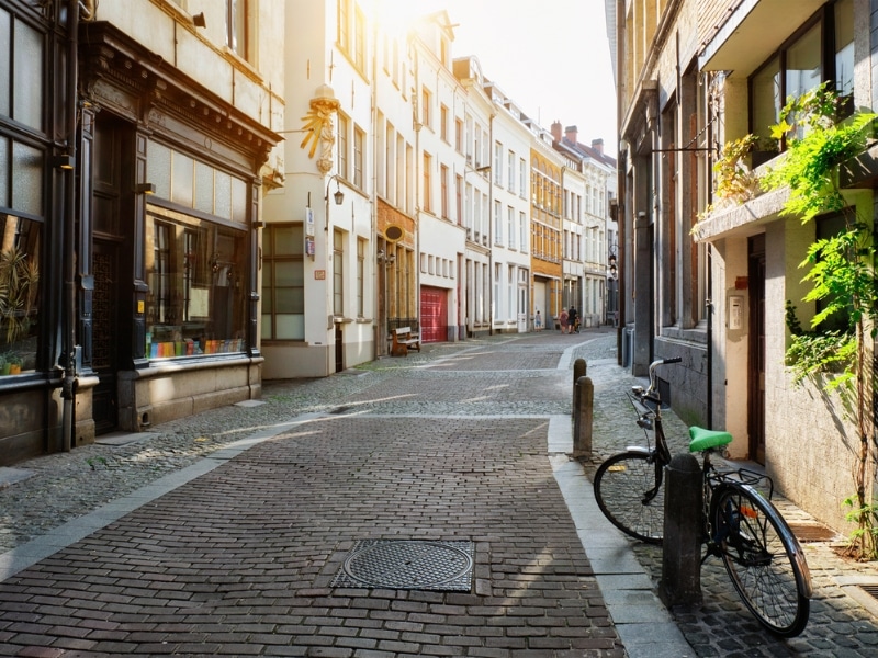 cobbled street lined with tall buildings and a bike in the foreground