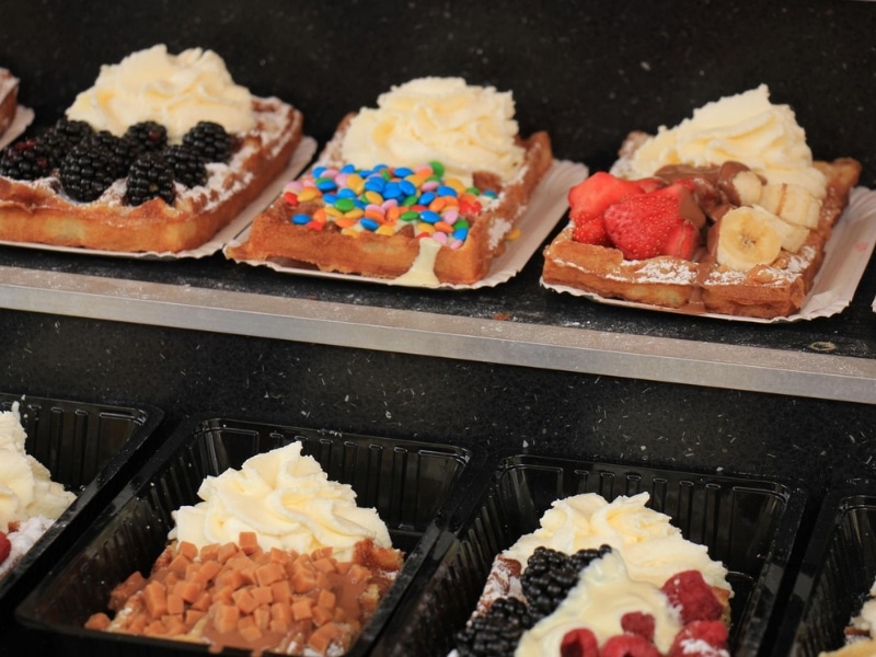 waffles with different toppings on display in a shop