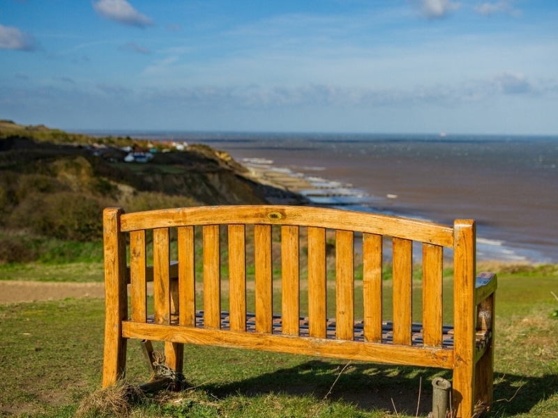 wooden bench on a cliff overlooking the sea