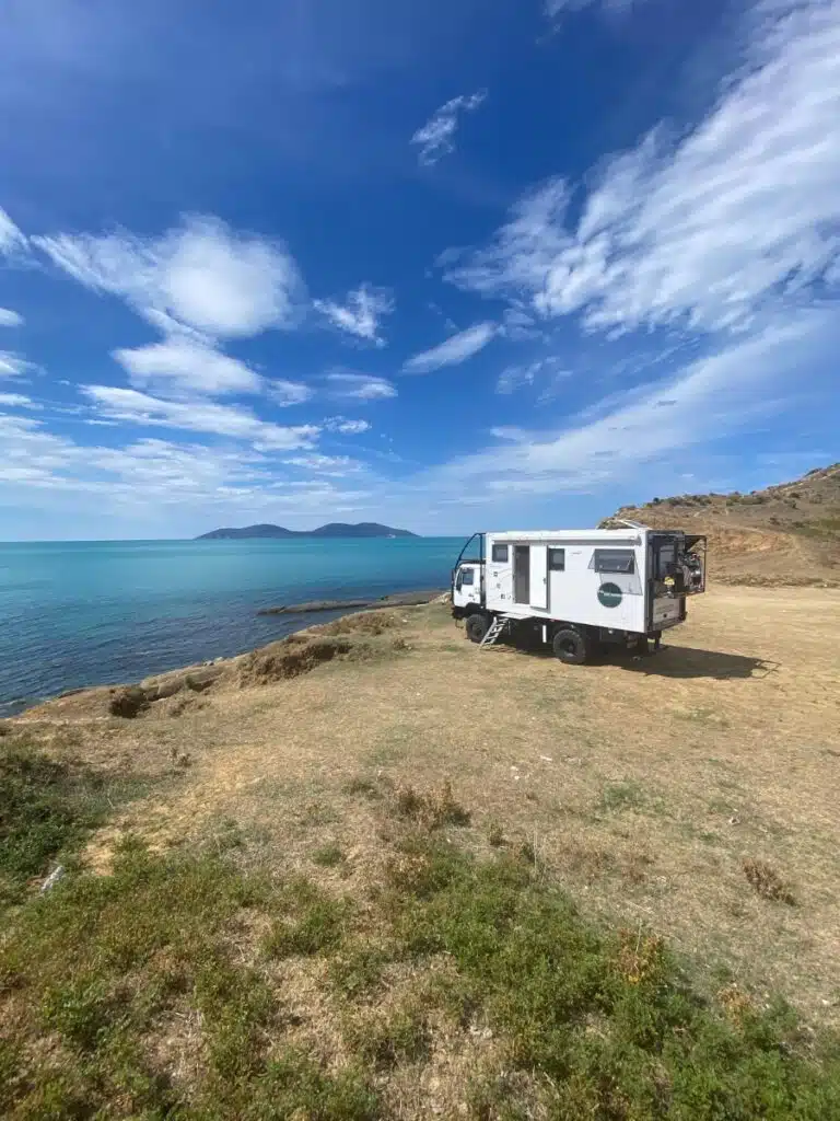 motorhome parked by the sea pn a patch of grass