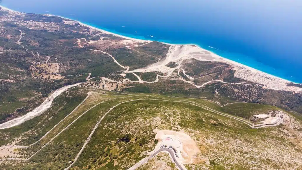 arial view of a long sandy coastline and azure blue sea