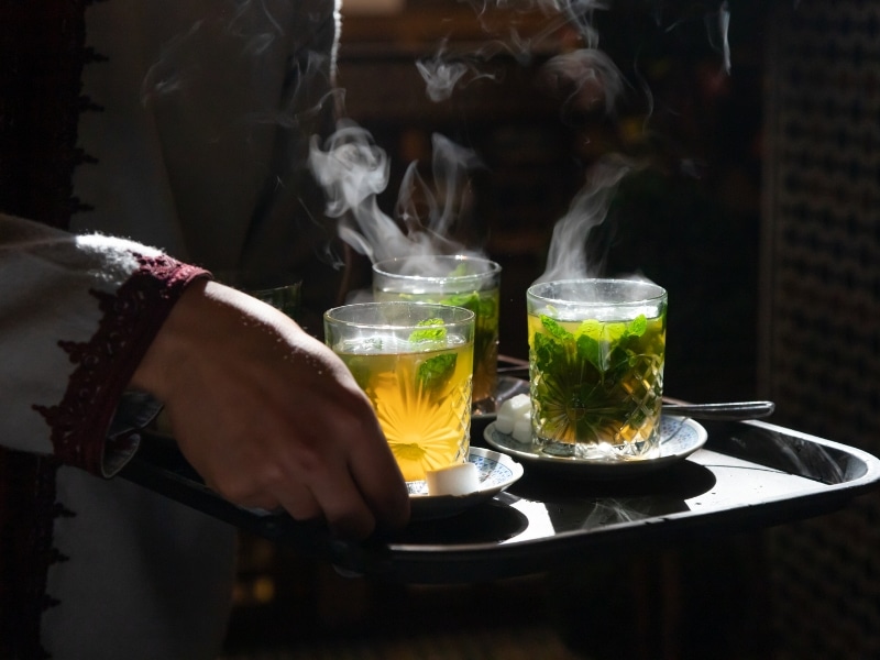 steaming glasses of mint tea on a tray