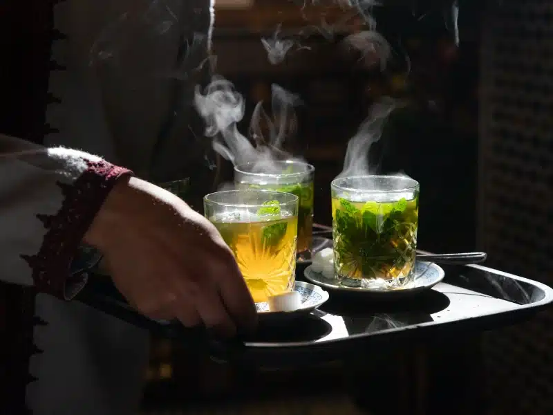 steaming glasses of mint tea on a tray