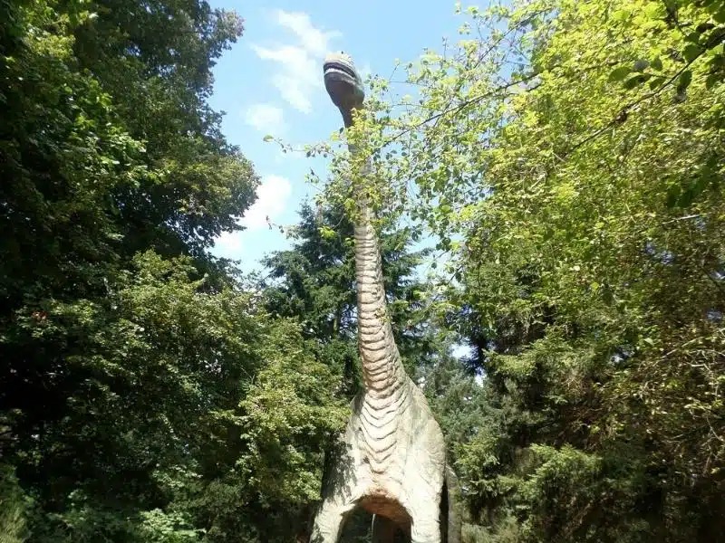 plastic dinosaur in the woods