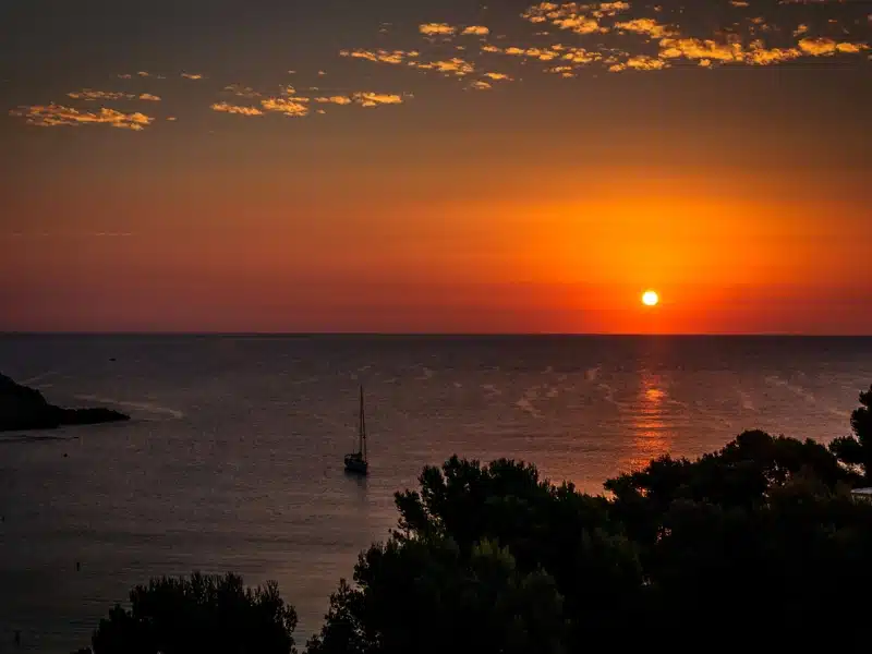 sunset over the sea and a boat in Mallorca