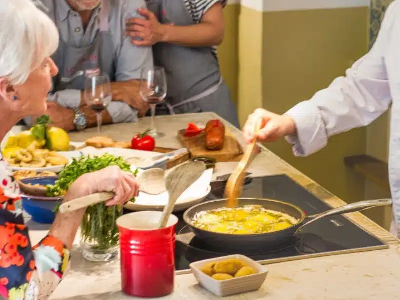 group of people watching a chef cooking