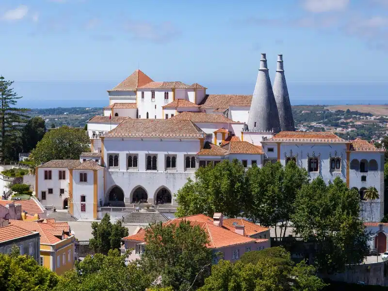 white palace with teracotta roofs and conical towers