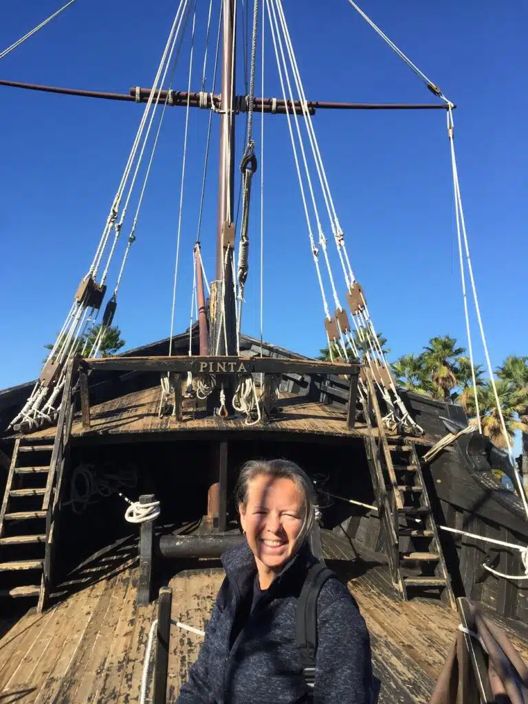 woman on a small open topped boat with rigging