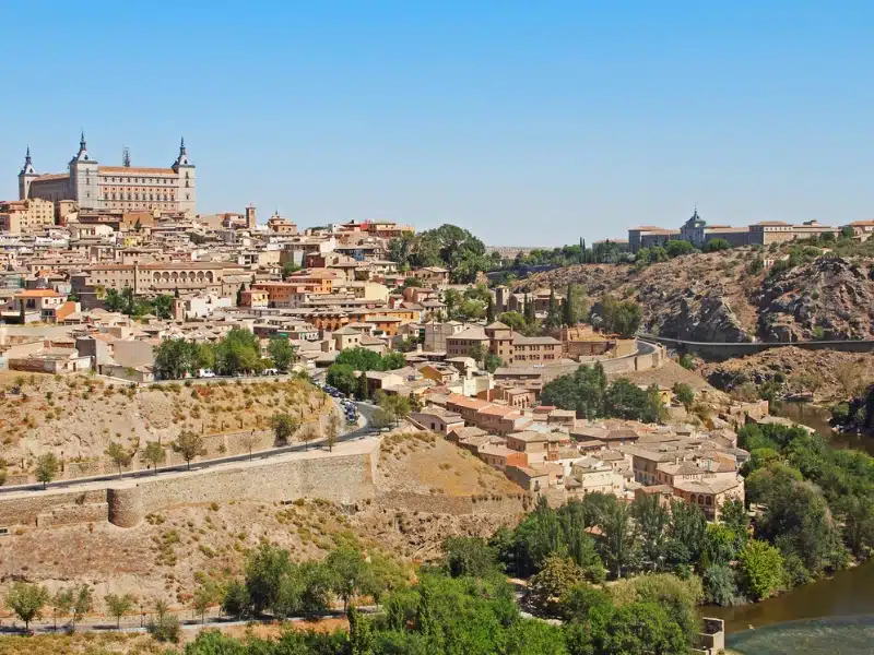 historic city rising froma. river up a hill to a large towered cathedral at the top of the hill