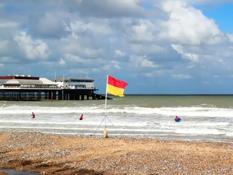 Surfers in the sea by Cromer Pier