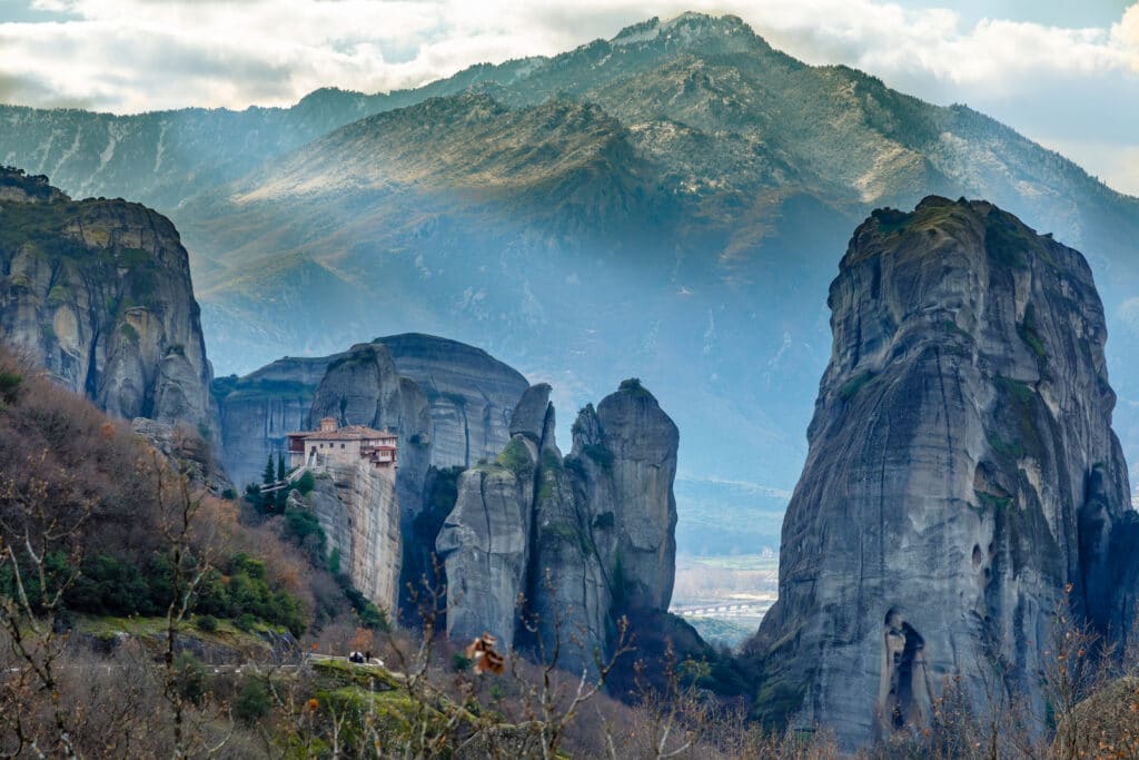 obelisk rocks with mountains in the background