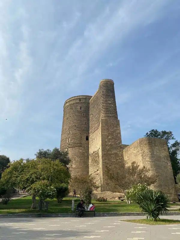 Stone tower on a small grassy mound with trees