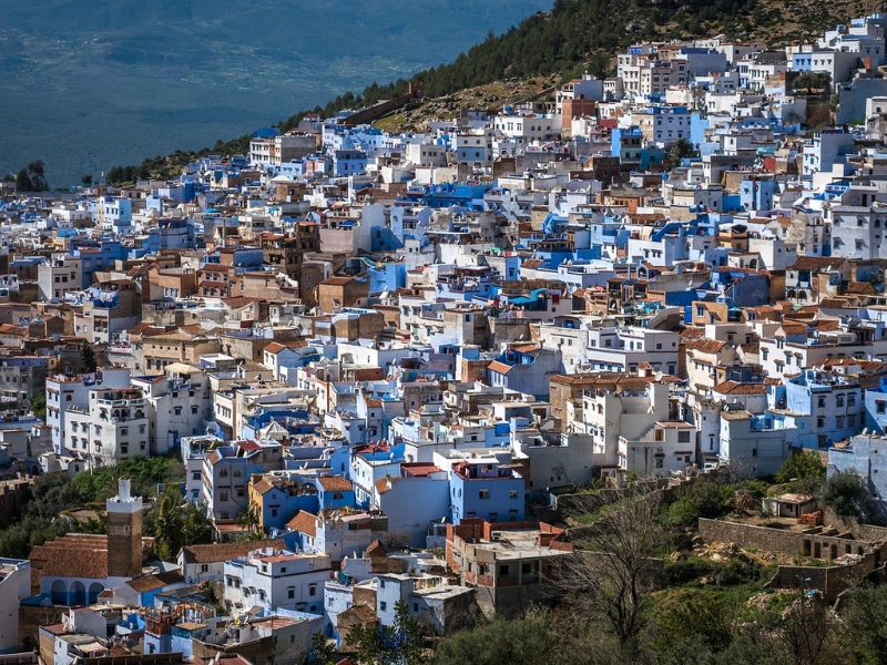 white a blue buildings on a hillside seen from above