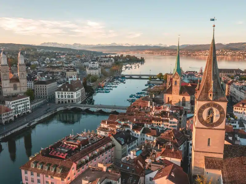 a wide river leading to a lake with buildings and churches on either side