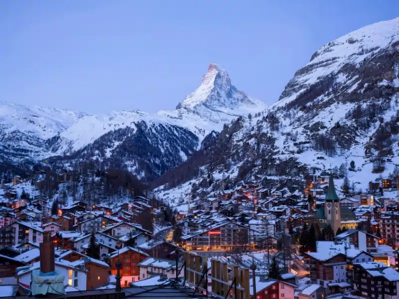 Swiss mountain town surrouned by snowy mountains