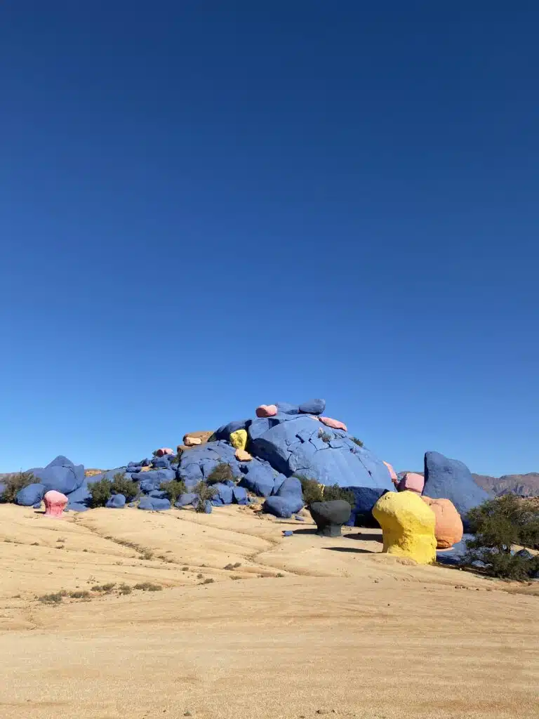 large rock cluster painted blue, yellow and pink