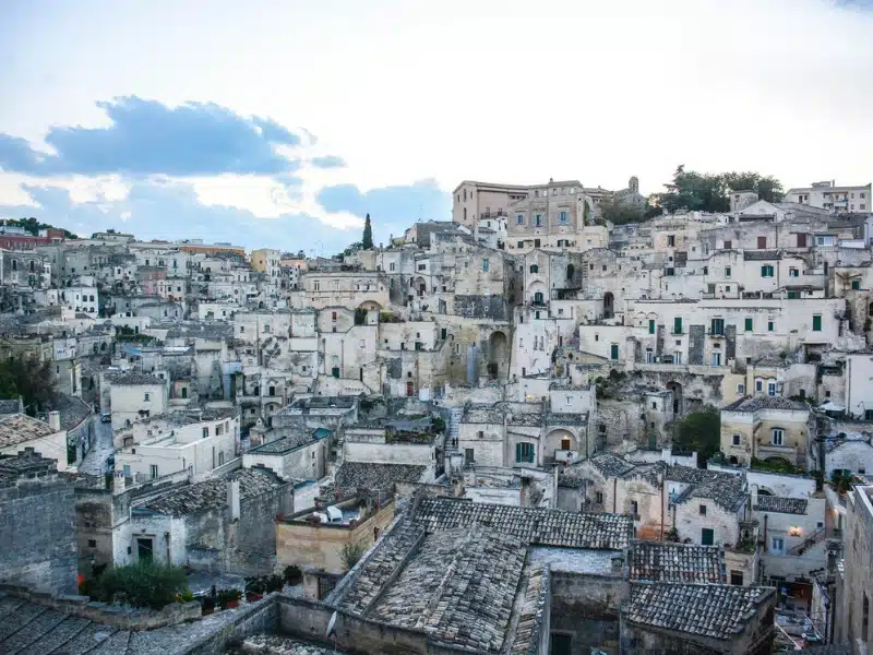 grey and white cave houses built on a hillside