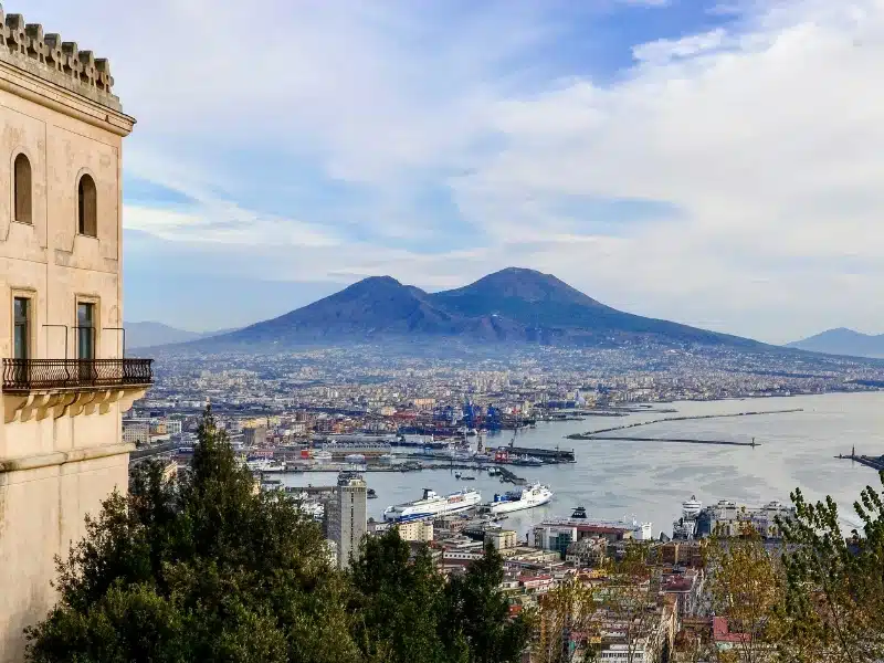 The city of Naples seen from a high viewpoint with Mount Vesuvius in the distance