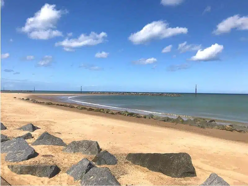 crescent shaped beach with rocks