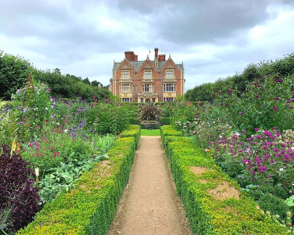 An Edwardian country house fronted by lush herbaceous borders and box hedging