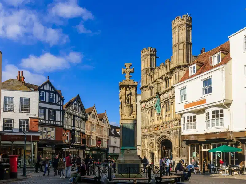 historic market place with half-timbered buildings and a central memorial