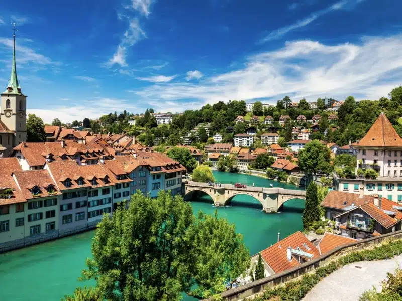 red roofed city with a turquoise river and spires