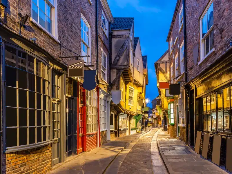 historic half timbered buildings living a cobbled street at twilight