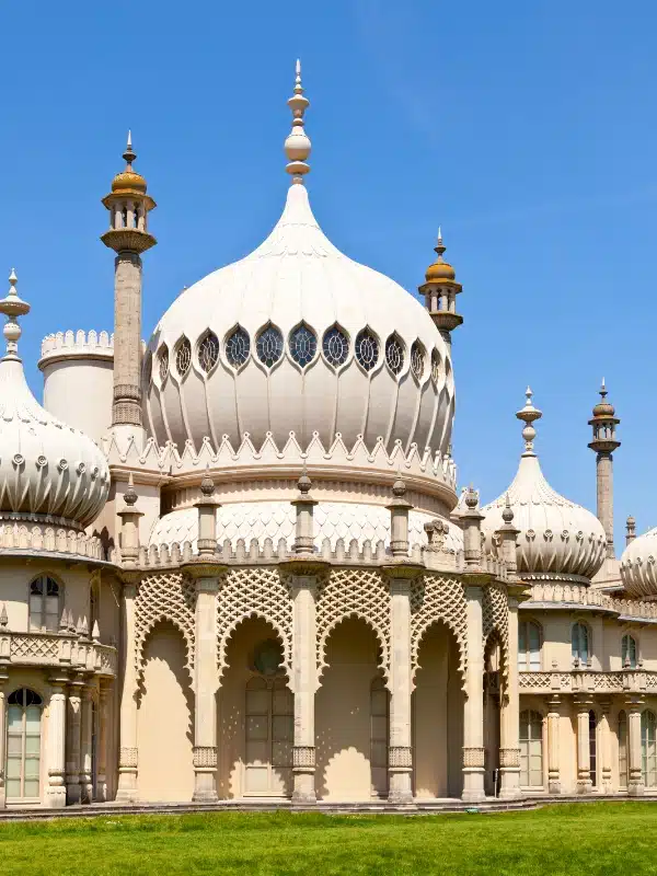 pale and ornate building with many arches, onion domes and towers